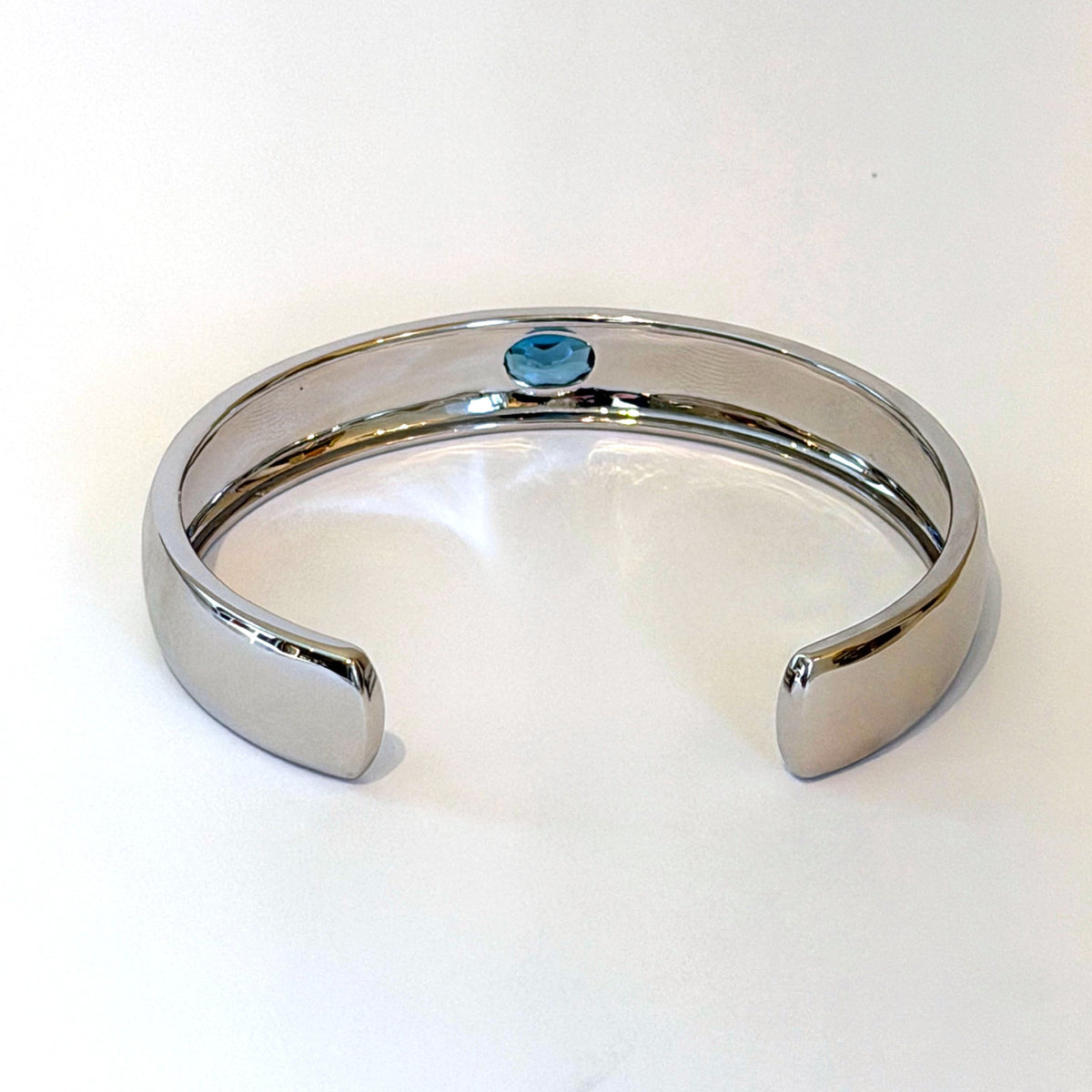 Sterling silver cuff bracelet with oval blue zircon by Scott Spurling, view of the open back