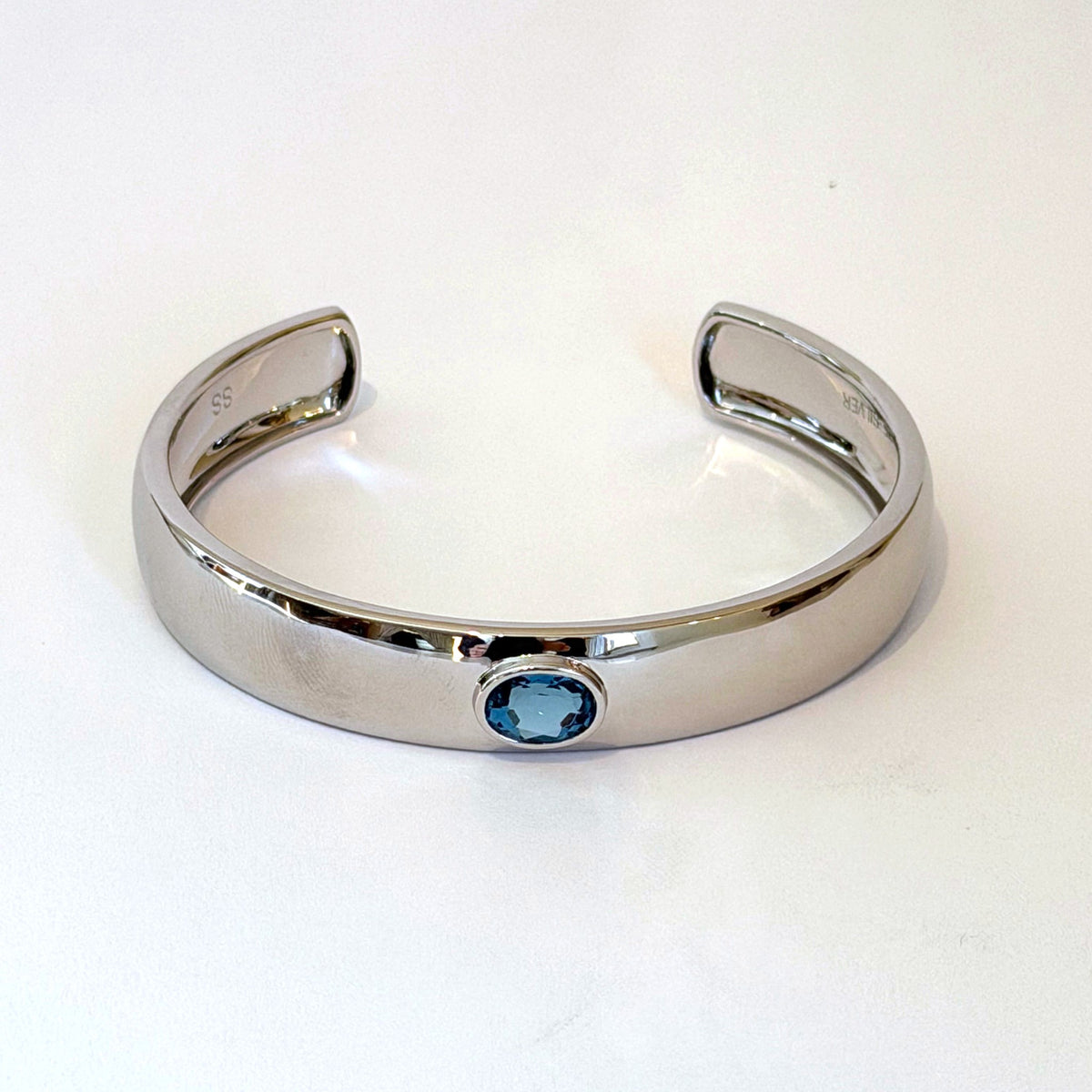 Sterling silver cuff bracelet with oval blue zircon by Scott Spurling, front view